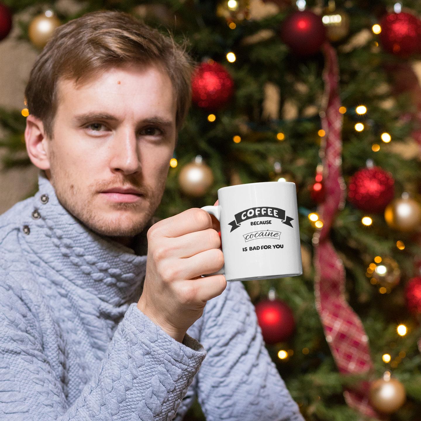 man-holding-coffee-mug-with-funny-text-in-Christmas-decor