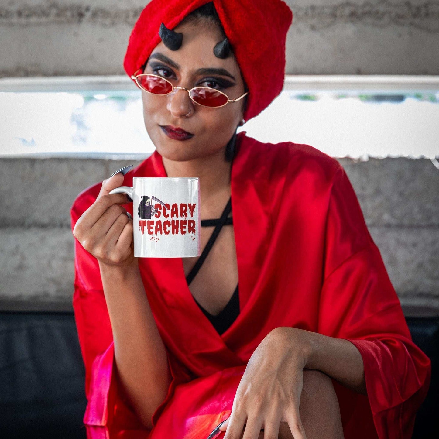 devil-disguised-woman-holding-halloween-mug