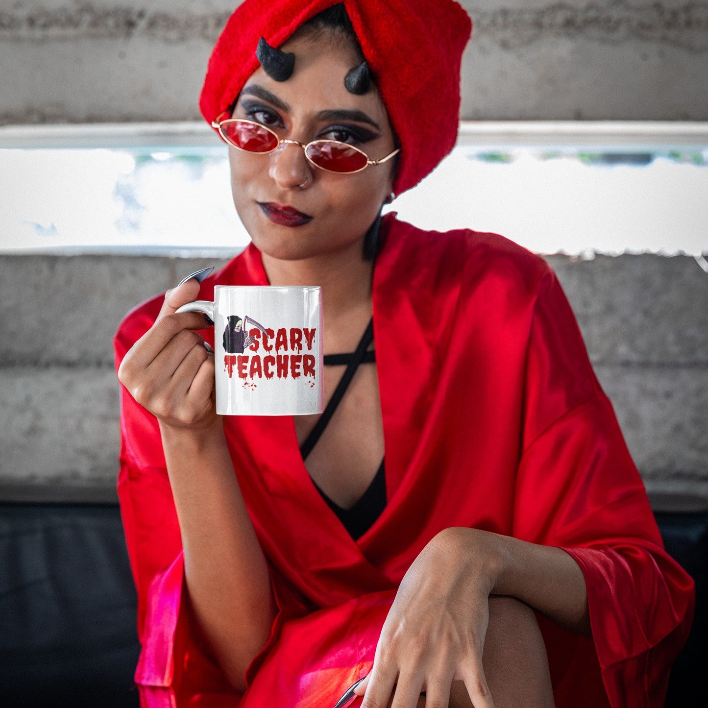 devil-disguised-woman-holding-halloween-mug