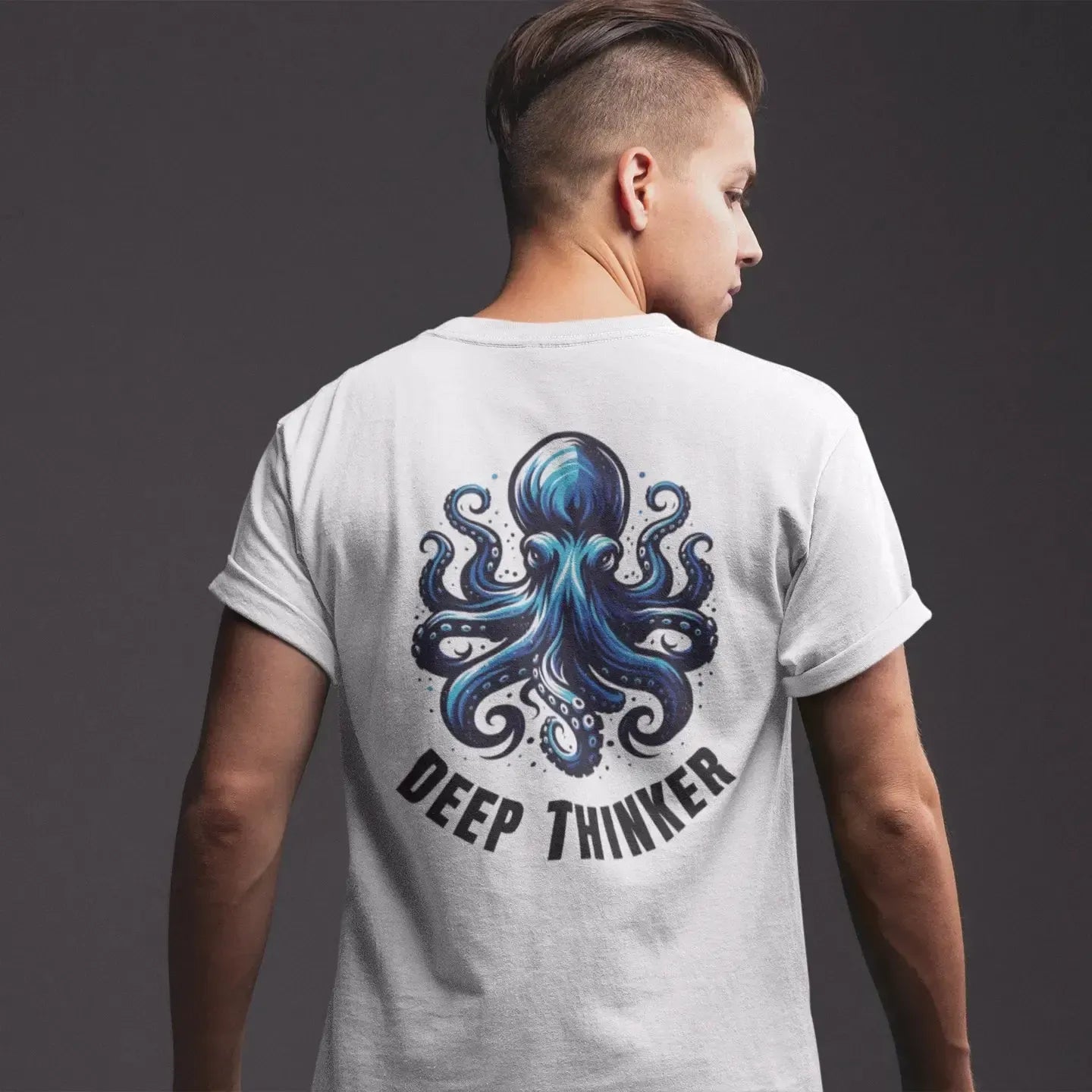 Person wearing a t-shirt with an octopus design and 'Deep Thinker' text on the back against a dark background