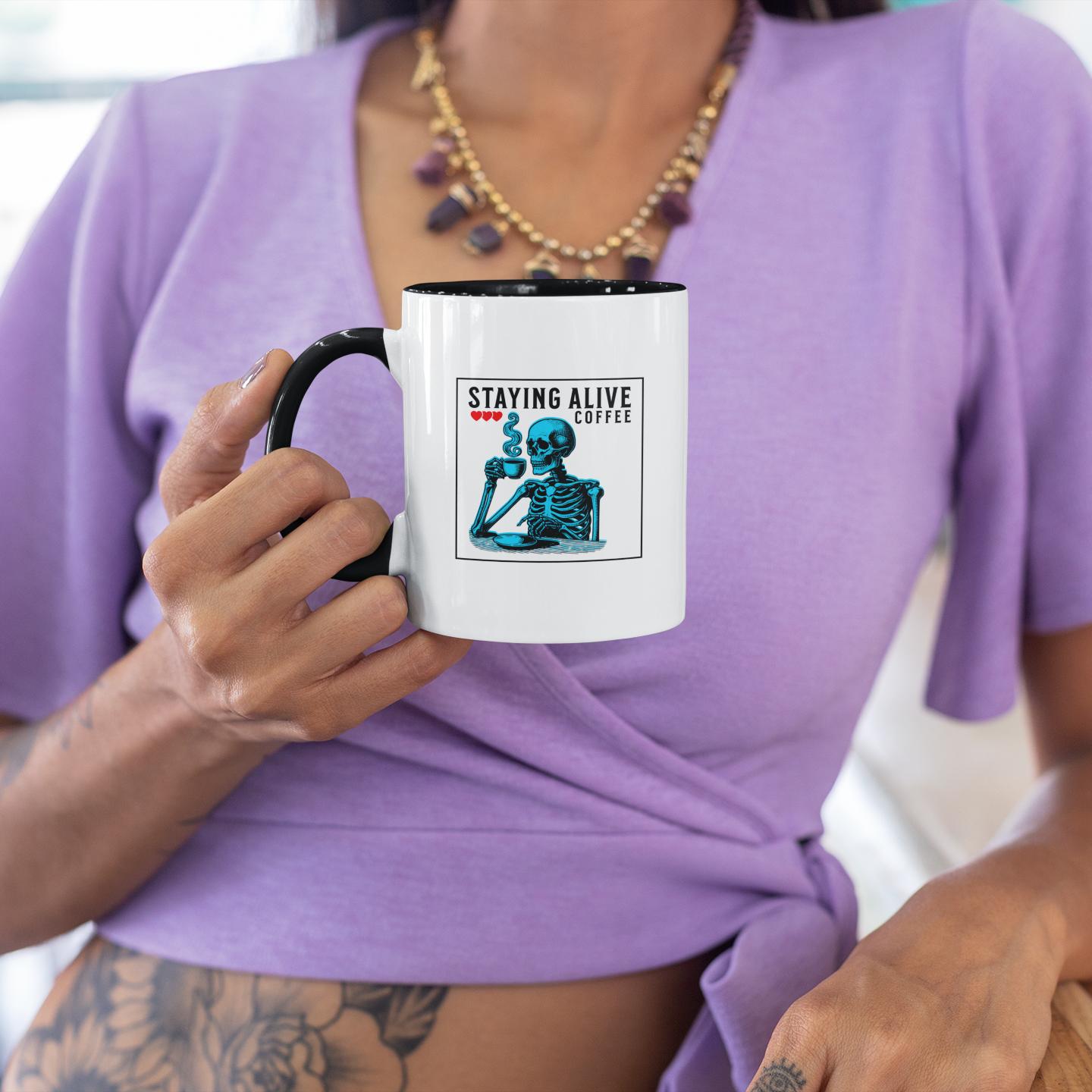 woman-holding-sarcastic-staying-alive-blue-skeleton-mug